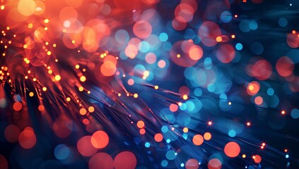 Blurred light blue and red background with fiber optic cables, with small orange dots in the foreground. Abstract concept of speed and technology