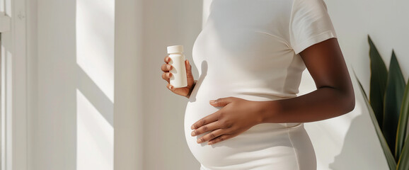 Pregnant healthy black woman holding generic white plastic medicine pill bottle