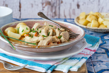 Pork in creamy mushroom sauce with boiled baby potatoes