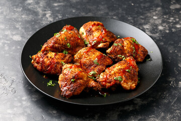 Chicken Thighs topped with buffalo sauce.