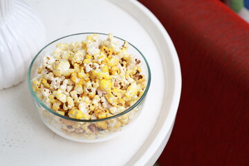 A bowl of popcorn on the table