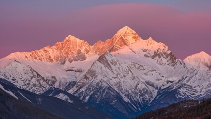 Obraz premium Snow-Capped Mountains Glow at Sunset