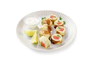 Homemade crepe rolls stuffed with salted salmon, cream cheese and fresh cucumber. Delicious appetizer. isolated on white background