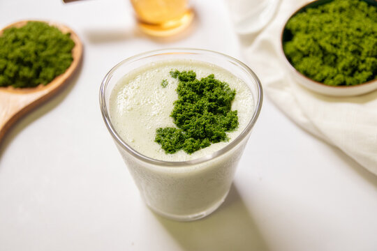 Healthy smoothie with greek yogurt and wolffia globosa in glass isolated on white table background. Wolffia globosa is the nutrient-rich plant-based source of protein and omega3 and vital minerals.