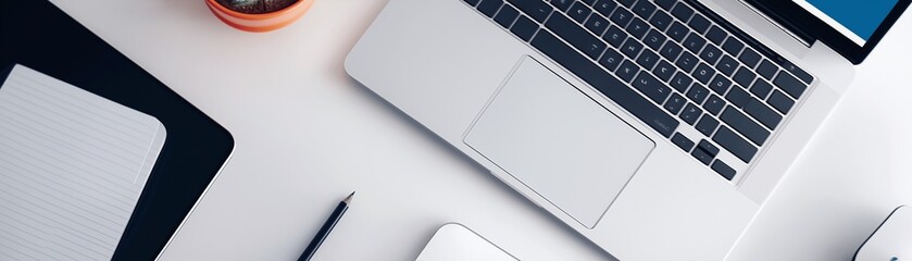 A workspace with a laptop and other office supplies.