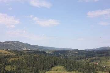 Picturesque view of forest in mountains under blue sky