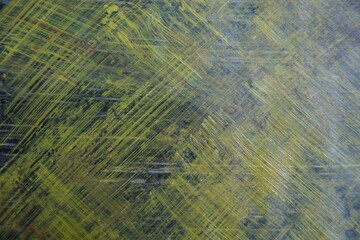 Abstract yellow acrylic paint splatter on turquoise paint surface, Colorful messy paint splash...