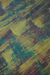 Fototapeta premium Abstract yellow acrylic paint splatter on turquoise paint surface, Colorful messy paint splash textured background, Distressed mixed color pattern strokes backdrop