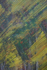 Abstract yellow acrylic paint splatter on turquoise paint surface, Colorful messy paint splash textured background, Distressed mixed color pattern strokes backdrop