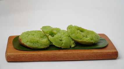 Cara bika or carabikang cake, traditional Indonesian cake on a wooden plate isolated on a white...