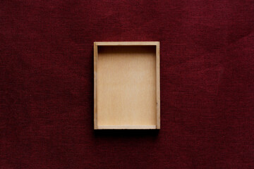 Flatlay background pine wood box on red velvet jute fabric for christmas and chinese new year...