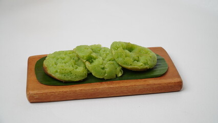 Cara bika or carabikang cake, traditional Indonesian cake on a wooden plate isolated on a white...
