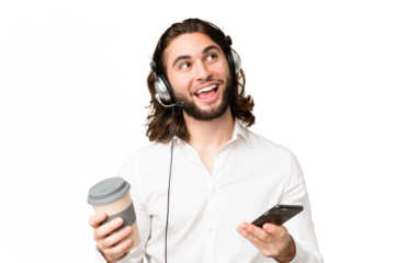 Telemarketer man working with a headset over isolated chroma key background holding coffee to take away and a mobile