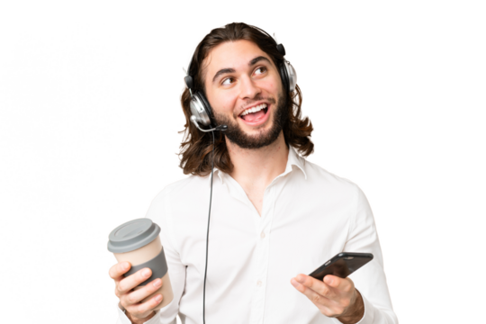 Telemarketer man working with a headset over isolated chroma key background holding coffee to take away and a mobile