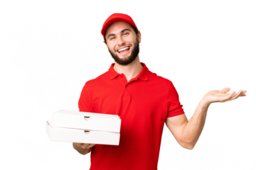 pizza delivery man with work uniform picking up pizza boxes over isolated chroma key background with shocked facial expression