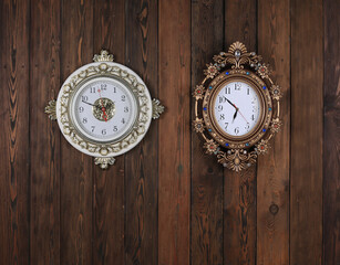 vintage wall ornamental clock on old wooden background