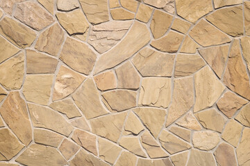 Beige stone wall background, light beige stone texture backdrop