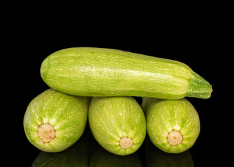 Several ripe zucchini, macro, isolated on black background.