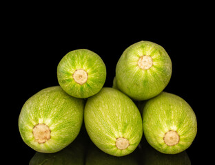 Several ripe zucchini, macro, isolated on black background.
