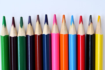 multi-colored pencils for drawing on a white background close-up
