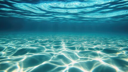 Obraz premium Crystal-clear water with a cool, blue tint, gently rippling under the sun.