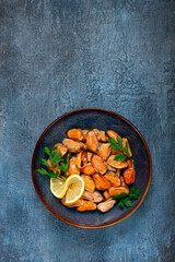 mussels no shell, boiled, mussels, peeled, in a bowl, with lemon and parsley, Chilean mussels, top view, no people,