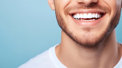 Fototapeta premium Close-up of a young Caucasian man smiling brightly, showcasing his perfect teeth against a soft blue background. A lively and cheerful expression embodies happiness.