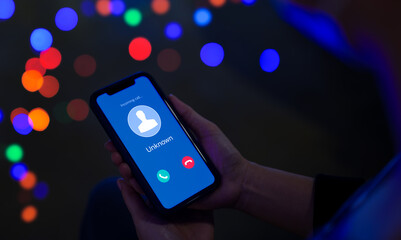 Woman holding mobile phone with incoming call from an unknown caller. scammer or stranger, Hoax...