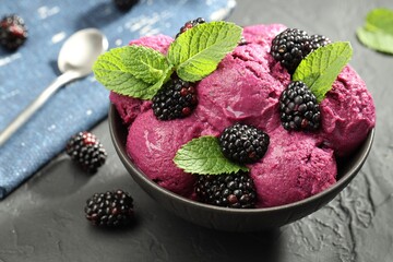 Delicious blackberry sorbet, fresh berries and mint in bowl on gray textured table, closeup