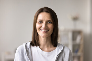 Head shot portrait of pretty middle-aged woman with attractive appearance and candid wide toothy...