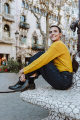 Fototapeta premium young hispanic woman skinhead or short hair in city, Portrait of Latin female in the street outdoors in autumn season 