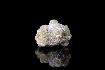 demantoid green garnet wrapped in asbestos fiber. Specimen from Dossi di Franscia, Italy. photography isolated on black background. macro detail close-up mineral crystal.
