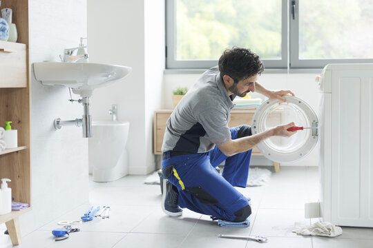 Technician repairing a washing machine