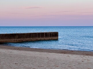 pier on the beach at sunset