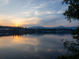 Sunset over Lake Placid with Adirondack Mountains in the background across Mirror Lake in Upstate New York, USA.