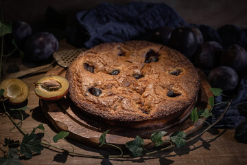Still life with plum cake and fresh plums