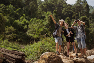 A group of teenagers hiking and enjoying nature, a group of young friends exploring the great outdoors in the mountains, embracing an active lifestyle in nature. laughing and enjoying the outdoors.