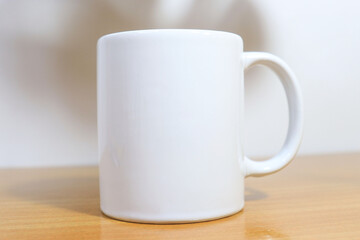 white cup on wooden table