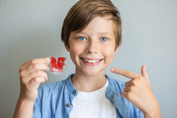 Teenage boy wearing orthodontic braces and showing. Teeth with orthodontic brackets. Dental health care