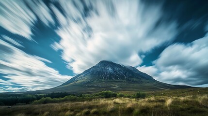 Mountain Peak Under A Swirling Cloud Formation
