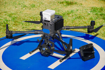 Industrial quadcopter stands on the runway