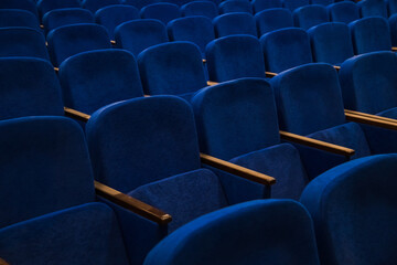 Blue empty seats in the audience prepared for the participants of the conference or presentation