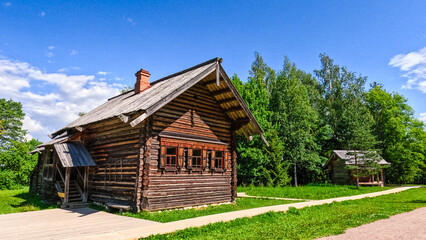 Old wooden house in the village on a sunny summer day