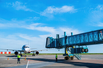 Jet bridge at the airport is brought to a large passenger plane