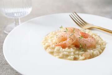 Delicious risotto with shrimps and cheese on table, closeup