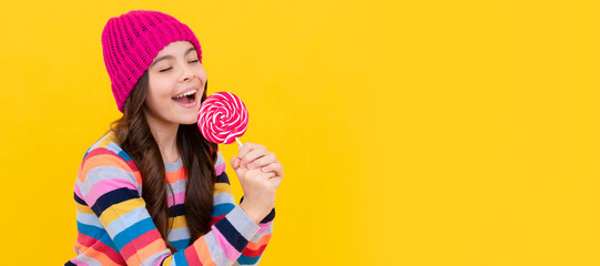 yummy. happy teen girl singer hold lollipop. lollipop lady. hipster kid with colorful lollypop. Teenager child with sweets, poster banner header, copy space.