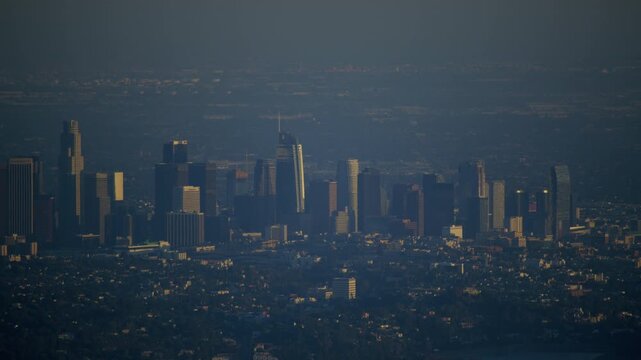 A top view of Los Angeles buildings, captured with a handheld camera under blue tones. The scene evokes feelings of alienation, distance, and loneliness, contrasting sharply with the usual warmth of t