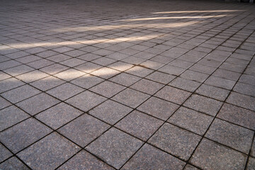 Fototapeta premium Full frame textured photo of the city sidewalk pavement with shadows