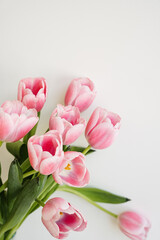 Fototapeta premium Pastel pink tulip flowers bouquet. Aesthetic holiday celebration concept