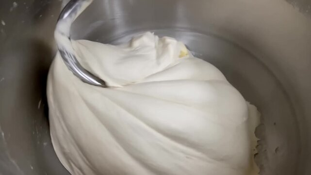 Close-up of an electric spiral kneading machine for kneading dough with butter